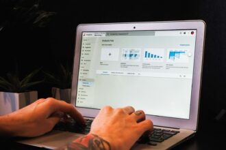 person using macbook pro on table